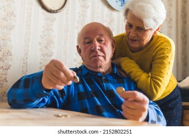 Senior Couple Counting Last Cents Medium Shot Living Room Money Concept. High Quality Photo