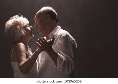 Senior Couple Dancing - Isolated On Dark Background