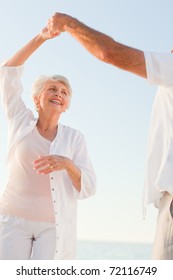 Senior Couple Dancing On The Beach