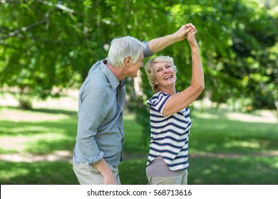 Senior couple dancing in park - Powered by Shutterstock
