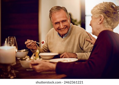 Senior, couple and dinner on date with love on anniversary in retirement with happy marriage. Elderly people, laughing and eating together in fine dining restaurant with food, care and relationship - Powered by Shutterstock