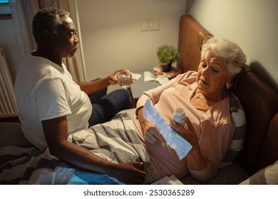 Senior couple discussing bills in bedroom at night - Powered by Shutterstock