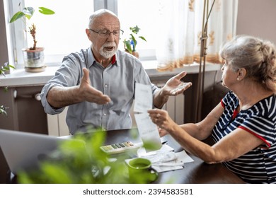 Senior couple discussing their home finances while sitting at the table - Powered by Shutterstock