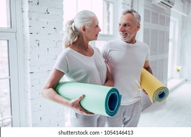 Senior Couple Is Doing Fitness Training At Home.Standing With Fitness Yoga Carpets. Healthy Lifestyle Concept.