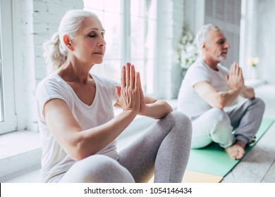 Senior couple is doing fitness training at home  Doing yoga together  Healthy lifestyle concept 
