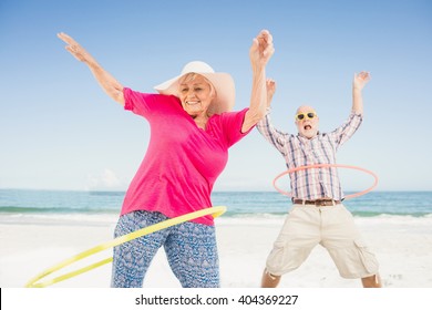 Senior couple doing hula hoop on the beach - Powered by Shutterstock