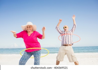 Senior couple doing hula hoop on the beach - Powered by Shutterstock