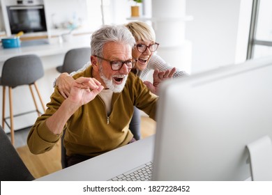 Senior Couple Doing Video Chat With Grandchildren Using Computer