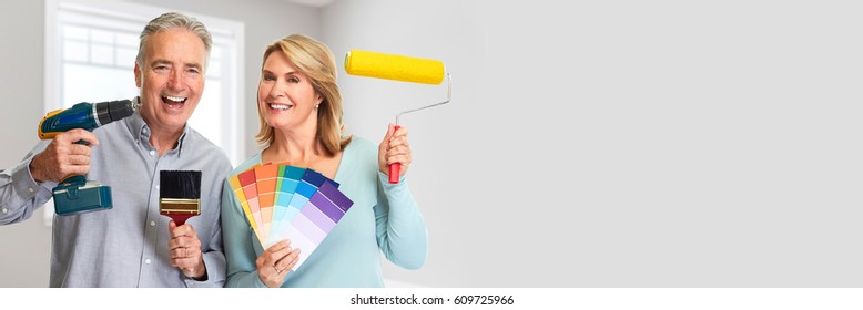 Senior Couple With Drill And Painting Roller