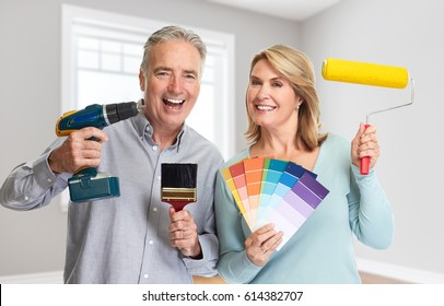 Senior Couple With Drill And Painting Roller