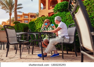 Senior couple drinking tea in hotel cafe. People enjoying vacation. Valentine's day
