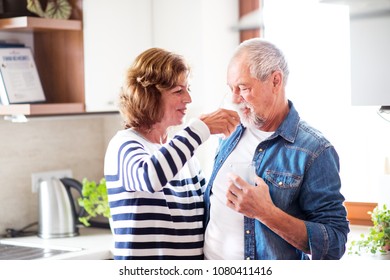 Senior Couple Drinking Water At Home.