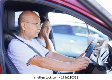 Senior Couple Driving A Car