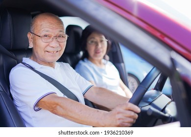 Senior Couple Driving A Car