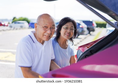 Senior Couple Driving A Car