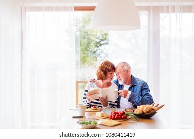 Senior Couple Eating Breakfast At Home.