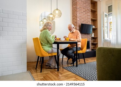 Senior Couple Eating Breakfast At Home.