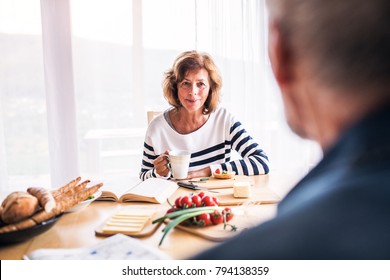 Senior Couple Eating Breakfast At Home.