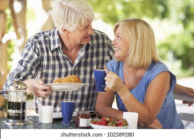 Senior Couple Eating Breakfast Outdoors