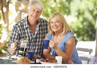 Senior Couple Eating Breakfast Outdoors