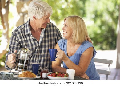 Senior Couple Eating Breakfast Outdoors