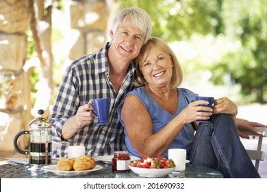 Senior Couple Eating Breakfast Outdoors