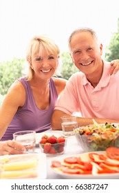 Senior Couple Eating Outdoors