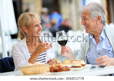 Senior couple eating Spanish fingerfood in Spain