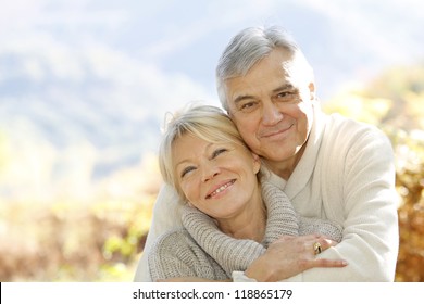 Senior couple embracing each other in countryside - Powered by Shutterstock