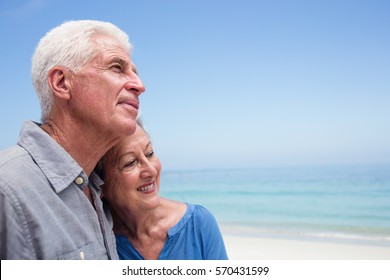 Senior couple embracing each other on the beach on a sunny day