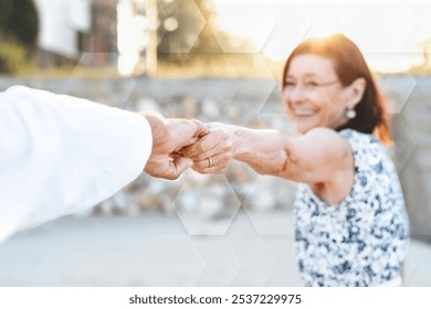 A senior couple enjoying the beach, Senior couple holding hands at the beach, happy senior woman holding hand with husband Love, relationship, and marriage life concept. Happy senior couple. - Powered by Shutterstock