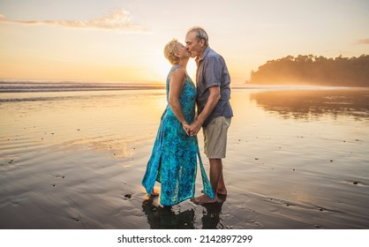 A Senior Couple Enjoying Beautiful Sunset on the Beach - Powered by Shutterstock