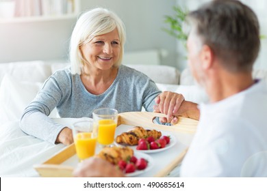 Senior couple enjoying breakfast in bed
 - Powered by Shutterstock