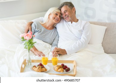 Senior couple enjoying breakfast in bed
 - Powered by Shutterstock