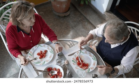 Senior Couple Enjoying a Light Meal Together Outdoors - Relaxed Dining Experience - Powered by Shutterstock