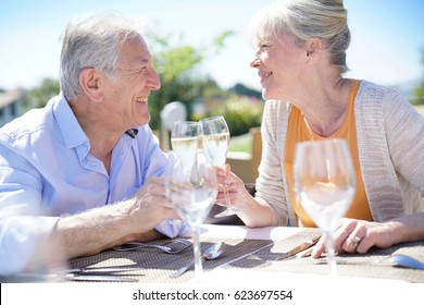 Senior couple enjoying meal in outdoor restaurant