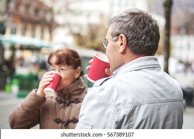 Senior Couple Enjoying Outside And Drinking Coffee.