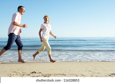 Senior Couple Enjoying Romantic Beach Holiday - Powered by Shutterstock