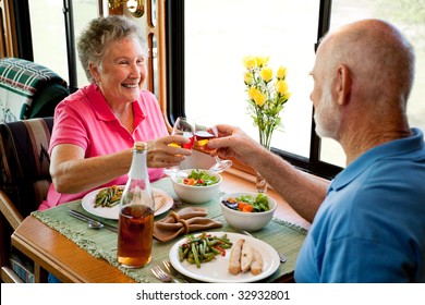 Senior couple enjoying a romantic dinner in their motor home.