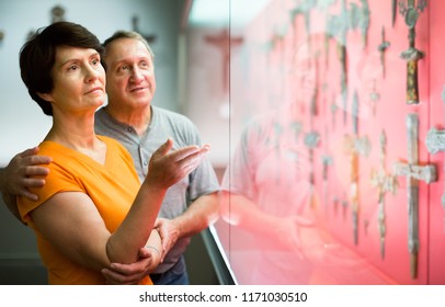 Senior Couple Examining Objects Applied Art On Expositions In Museum 