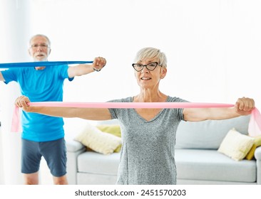 Senior couple exercise stretching resistance band at home, health care and active seniors concept - Powered by Shutterstock