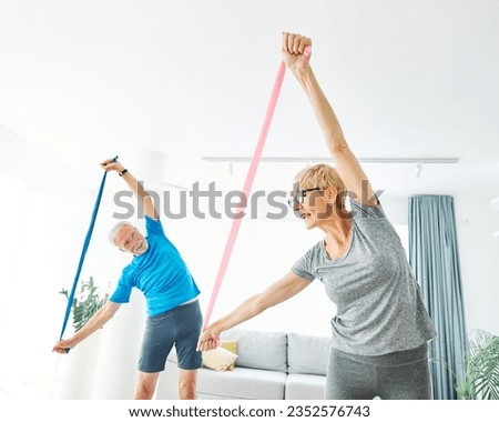 Senior couple exercise stretching resistance band at home, health care and active seniors concept