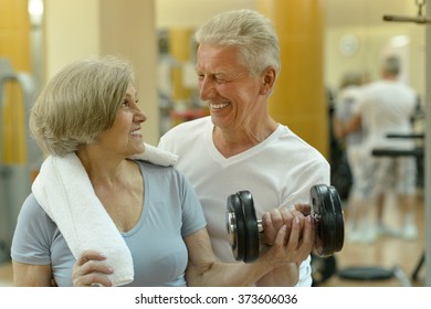 Senior Couple Exercising In Gym