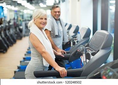 Senior Couple Exercising In Gym
