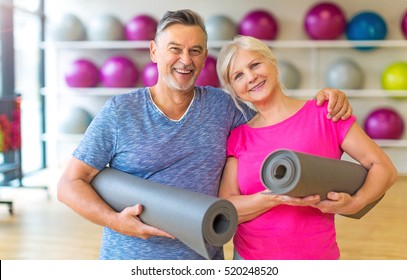 Senior Couple Exercising In Gym
