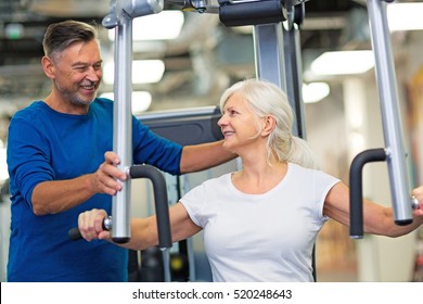 Senior couple exercising in gym
