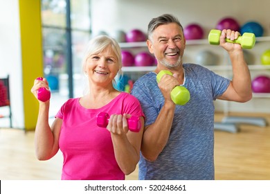 Senior Couple Exercising In Gym
