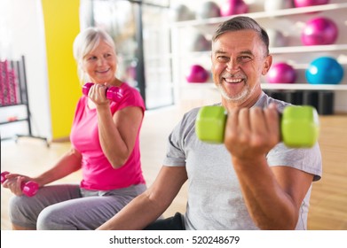 Senior Couple Exercising In Gym
