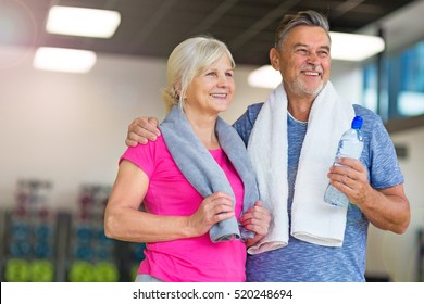 Senior Couple Exercising In Gym
