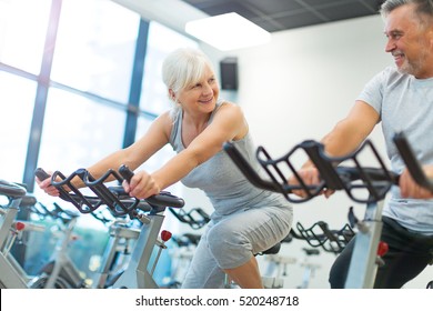 Senior Couple Exercising In Gym
